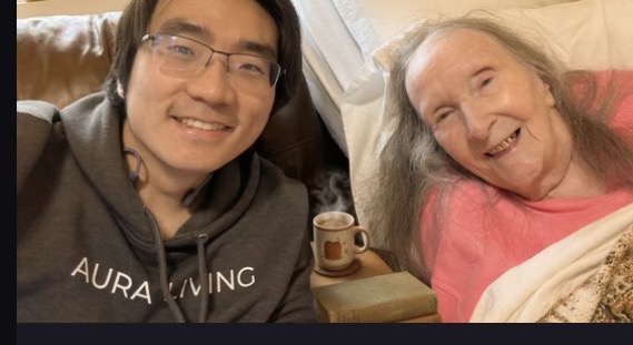 A family caregiver sharing a warm moment with an older adult at home